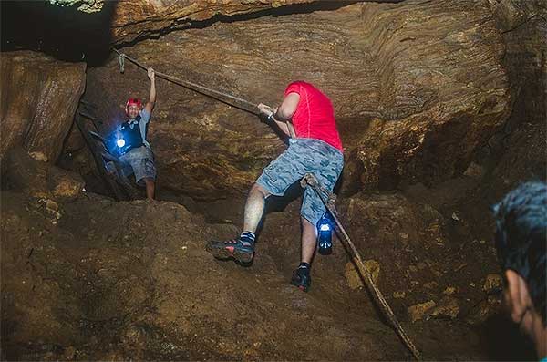 Climbers descending into Nil Diya Pokuna cave entrance