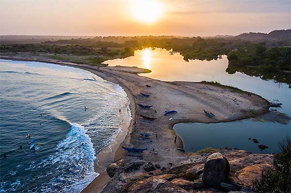 Arugam Bay surfers riding waves at sunrise